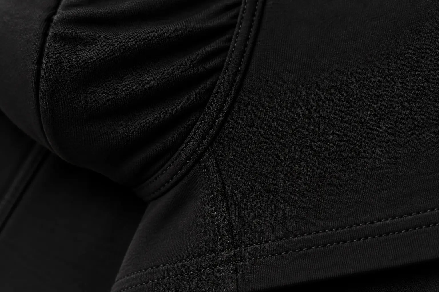 Close-up illustration of the curved pouch seam and double-stitched leg hem