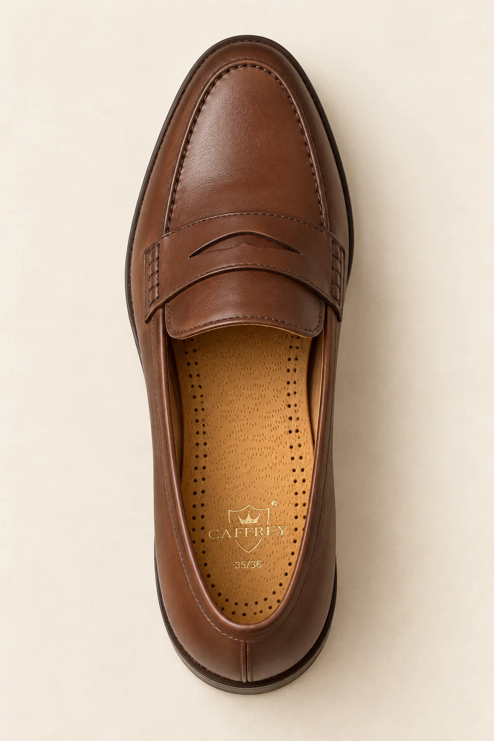 Eleganza tan leather insole seated flat inside a brown loafer