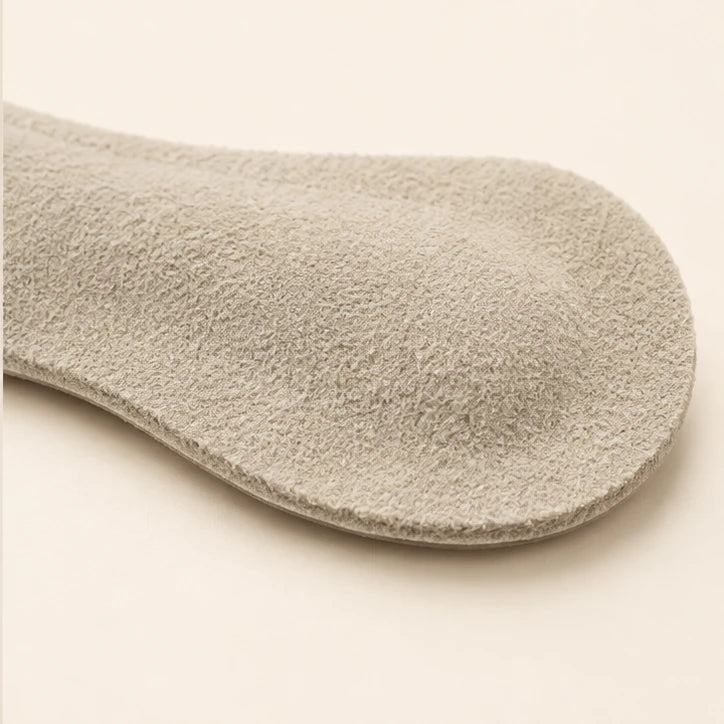 Close-up of the Off-white microsuede heel grip, with softly raised cushioning and a thin edge