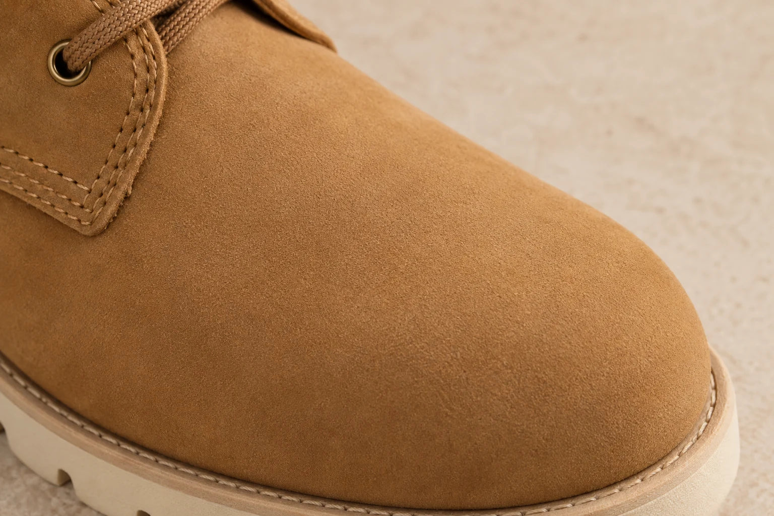 Illustrated close-up of the finely buffed, matte surface of a tan nubuck boot