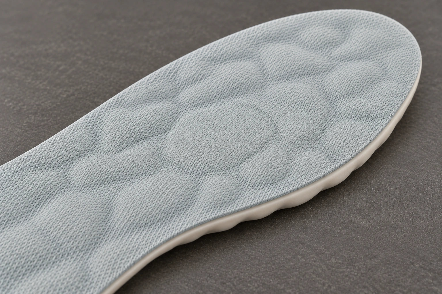 Close view of the grey Vital Step fabric over its pebble contours