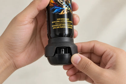 Close-up of hands turning the bottom Odo Fresh spray head to lock or unlock it