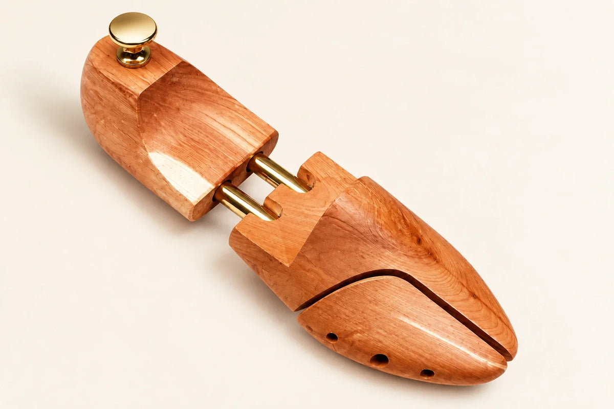 CAFFREY cedar shoe tree detail: split toe, twin gold-coloured tubes, shaped heel and round pull knob.