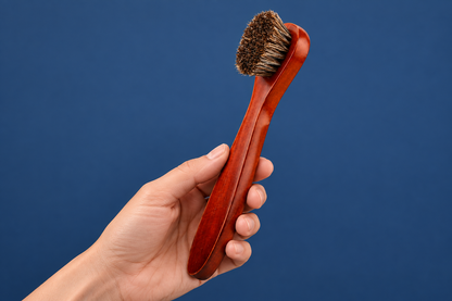 CAFFREY long-handled horsehair applicator held by its curved wooden handle