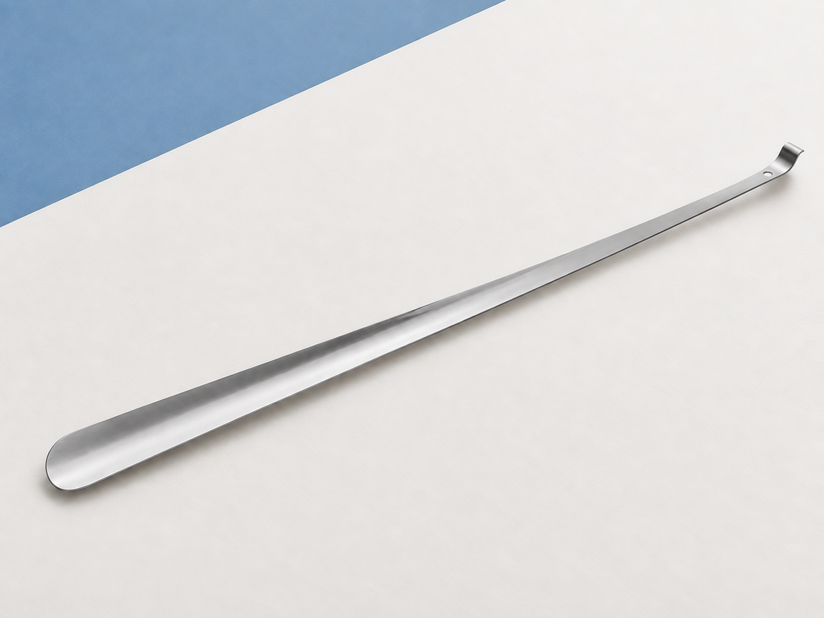 Long stainless steel shoe horn showing the narrow shaft, rounded blade and simple turned handle