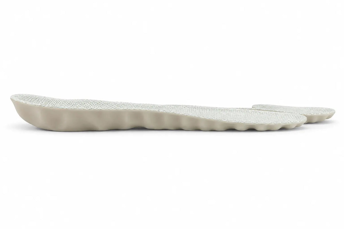 Side profile of CAFFREY Vital Step showing grey fabric over the shaped white base