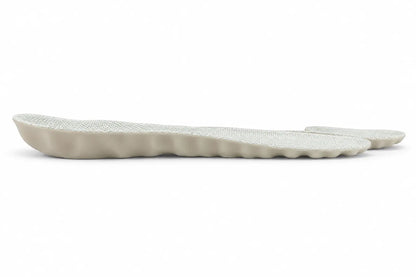 Side profile of CAFFREY Vital Step showing grey fabric over the shaped white base