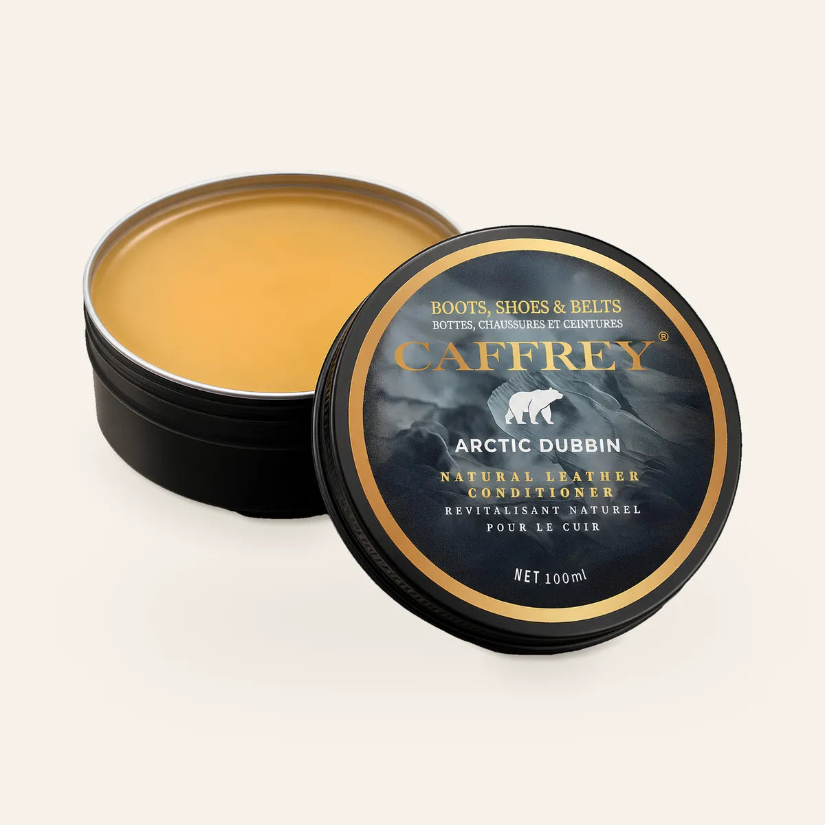 CAFFREY Arctic Dubbin 100 ml tin, open to show the amber balm, its polar-bear lid leaning against it