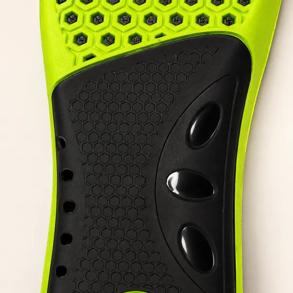 Close-up of the black arch panel on the underside, with glossy oval recesses, set into the lime base