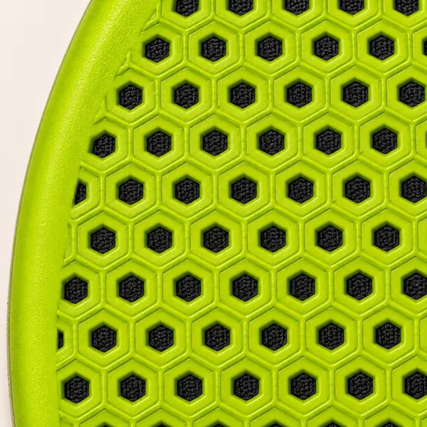 Close-up of the lime underside with rows of hexagon openings showing the black fabric through them