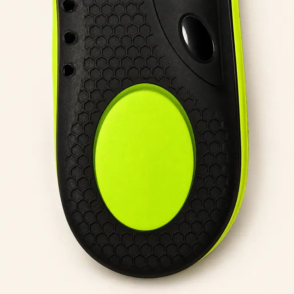 Close-up of the oval lime heel pad set into the black heel panel