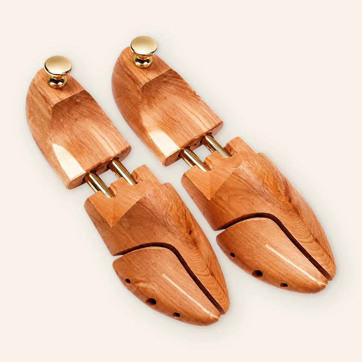 CAFFREY cedar shoe trees side by side, with split toes, twin gold-coloured tubes and round heel knobs.