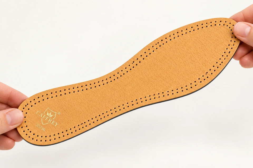 Hands holding Eleganza in a gentle bend, showing its thin flexible profile