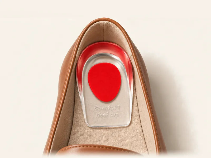 Illustration: red Women gel heel pad on the insole at the heel of a tan leather loafer, oval up
