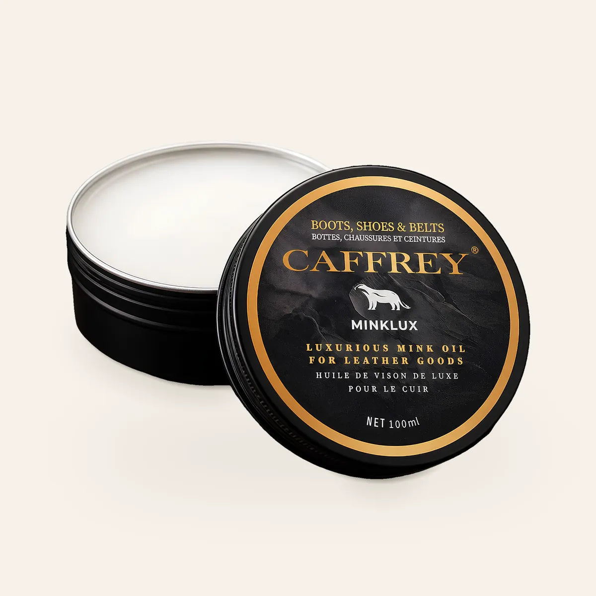CAFFREY Minklux mink oil: an open black 100 ml tin of white balm, its gold-ringed lid leaning against it