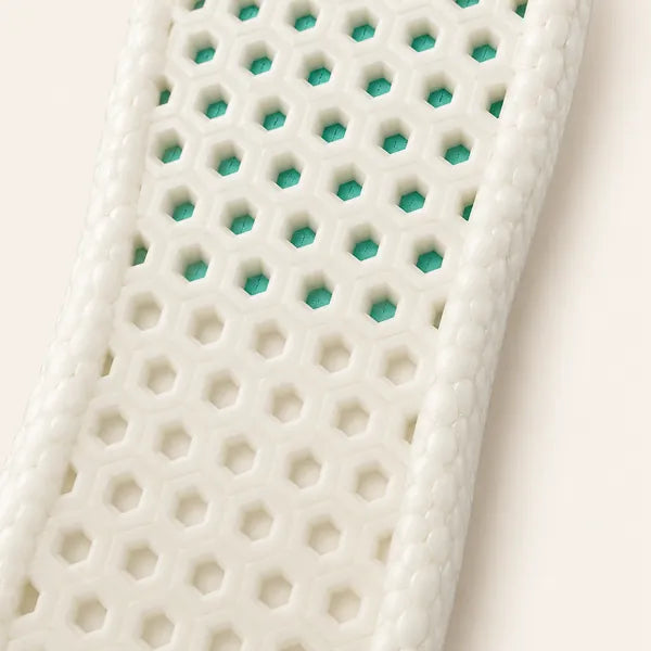 Close-up of the white Odour Smart base: open hexagons with green showing through, then shallow dimples at the heel