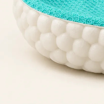 Edge of a CAFFREY Odour Smart insole: a green top layer on a thicker white base with a beaded rim