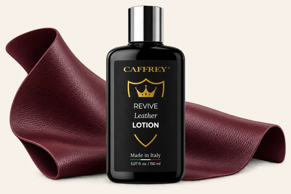 Illustration of the CAFFREY Revive Leather Lotion bottle in front of a soft fold of burgundy leather
