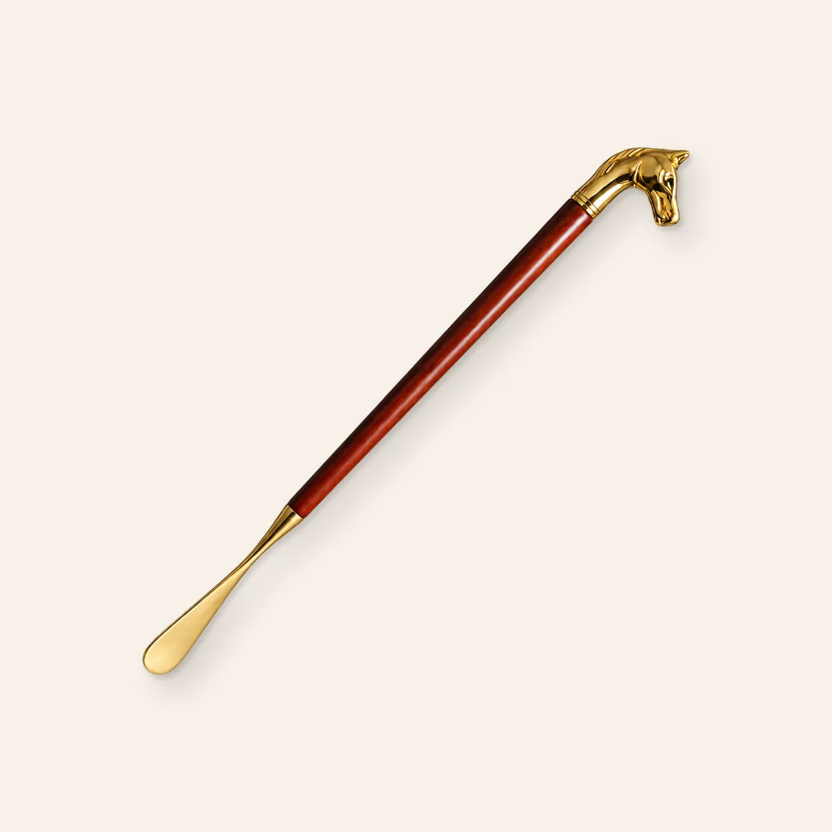 Illustration of the CAFFREY Royal Touch shoe horn with a gold-tone horse-head handle, polished wood shaft and curved blade