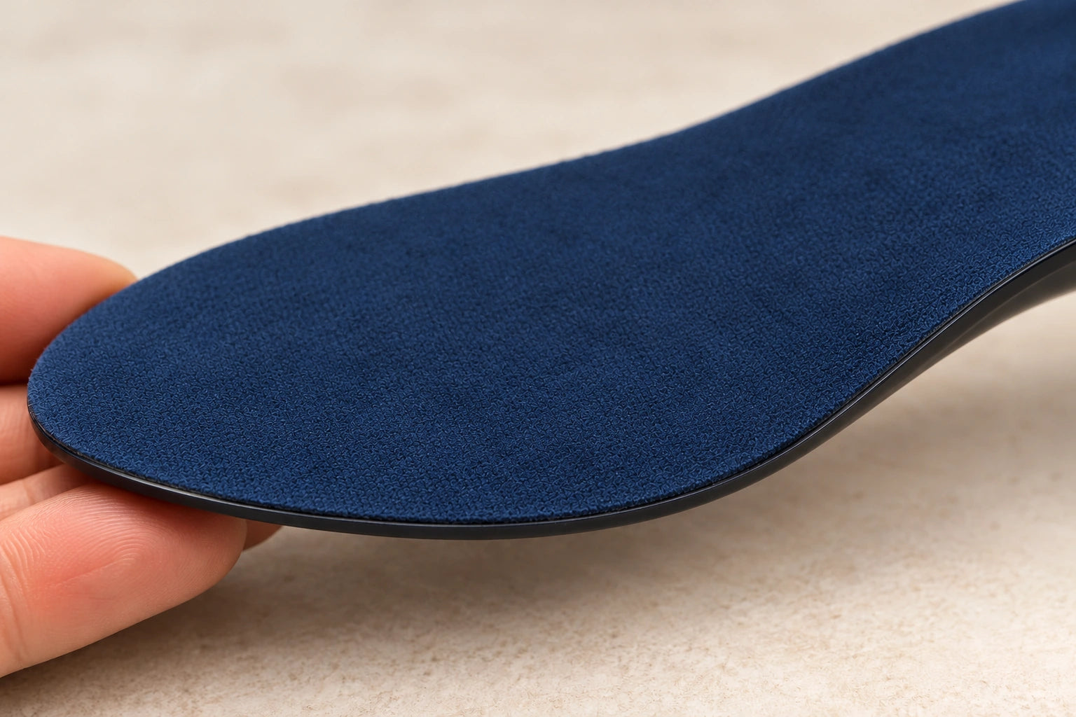 Close view of Step Aid’s navy fabric and thin attached dark edge, gently curved to show its flexibility