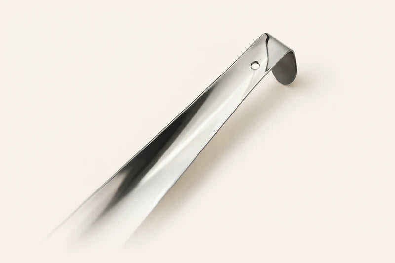Close-up illustration of the curled end and small hanging hole of a stainless steel shoe horn