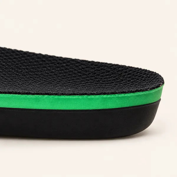 Side view of a Walk On Air insole heel: black knit top, bright green foam layer and black moulded shell