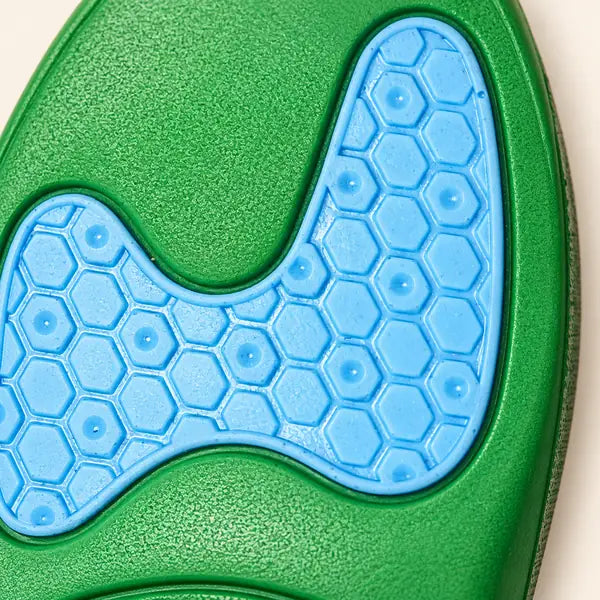 Macro of the blue honeycomb gel pad set into the green foam on the underside of a Walk On Air insole