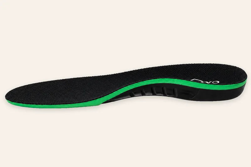 Side view of a CAFFREY Walk On Air insole: thin forefoot, raised black arch shell and deep heel cup